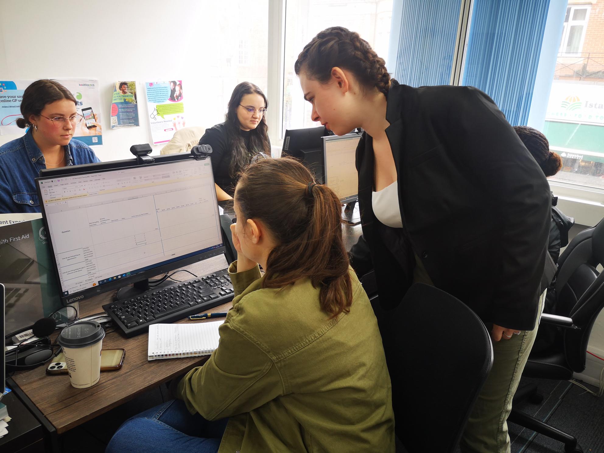 Melissa Cohen, intern, assisting volunteers during a patient experience training session