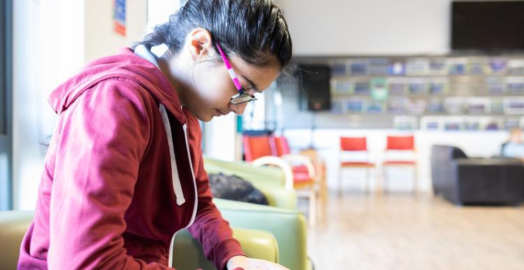 Young girl looking at her phone