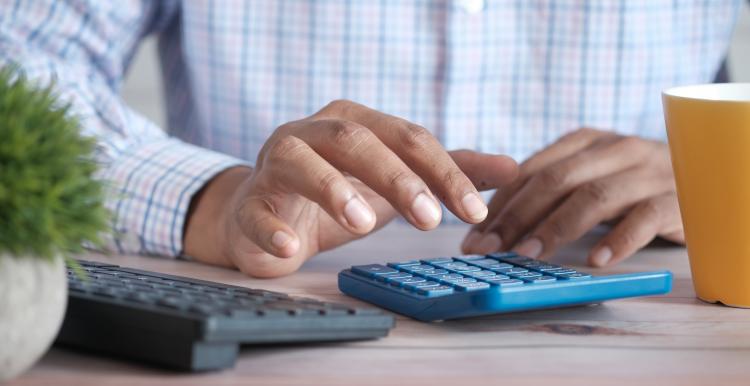 Hands using a calculator