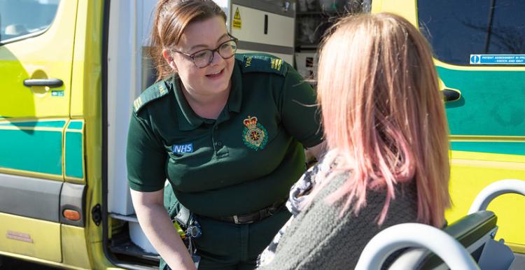 Ambulance driver with patient in wheelchair