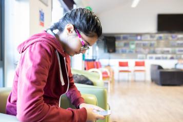 Young girl looking at her phone