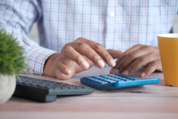 Hands using a calculator