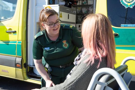 Ambulance driver with patient in wheelchair